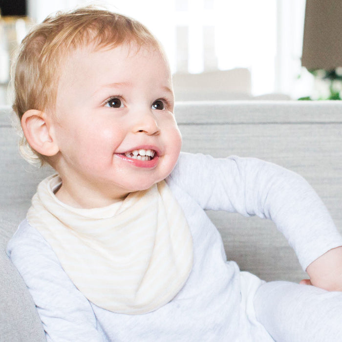 Baby posing in mori organic cotton milk bib
