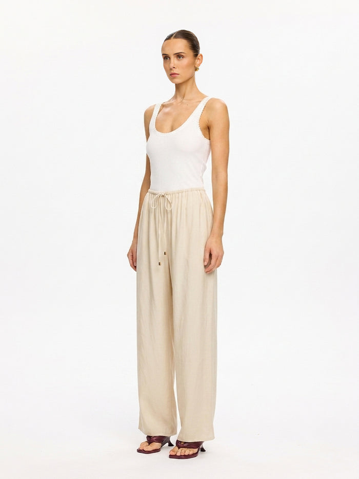 KIVARI Blythe Pant in Champagne – full-length side view of wide-leg pants with white tank top