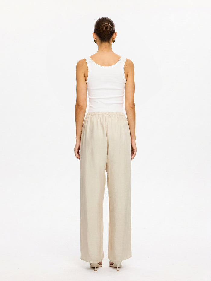 KIVARI Blythe Pant in Champagne – back view of wide-leg pants styled with white tank top