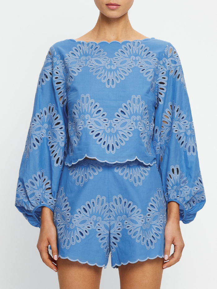 Blue lace top and shorts set on a white background