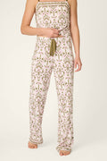 A person stands barefoot against a plain background, wearing P.J. Salvage's Déjà Vu Dreams Tiki Time Open Leg Pants; their head is not visible.