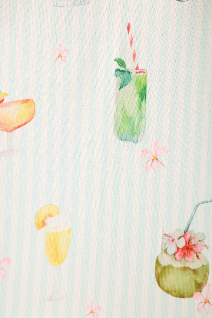 The fabric features watercolor illustrations of tropical drinks on a light background with vertical stripes.