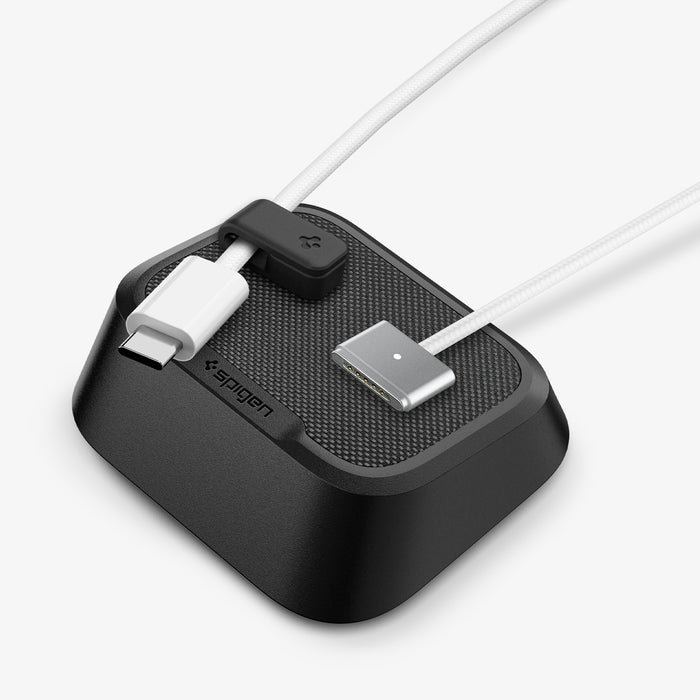 APP11145 - Magnetic Cable Holder | LD103 mounted on a light gray surface holding a MacBook charger and a white USB-C cable vertically in place