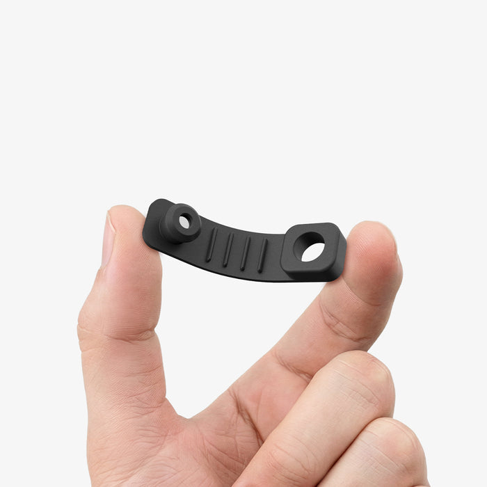 APP11145 - Magnetic Cable Holder | LD103 showing the flexible black strap held between fingers to demonstrate bendability