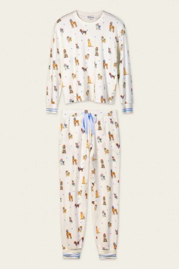 The Meet Me in Pawris Dog Print Long Sleeve PJ Set by P.J. Salvage features a white pajama set with light blue drawstring and cuffs, adorned with a playful print of small colorful dogs in various poses on a simple light beige background.