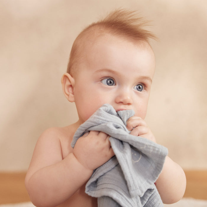 Baby holding MORI Pre-Washed Large Muslin