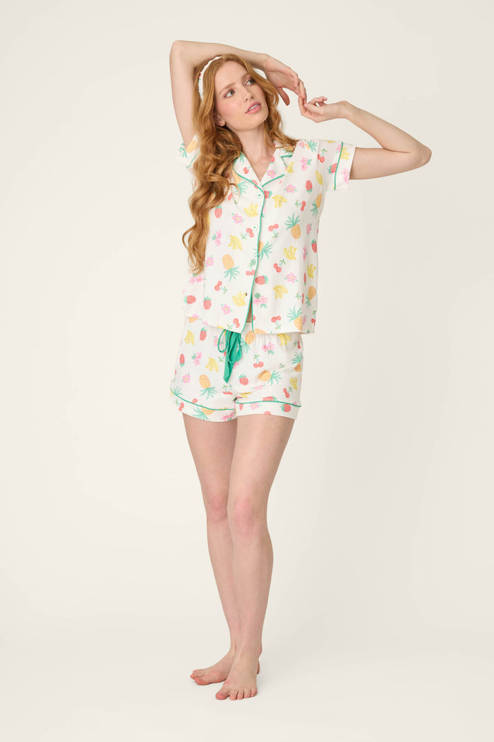 Vibrant fruit patterns in lively colors against a light background, with visually playful and fresh textile texture.