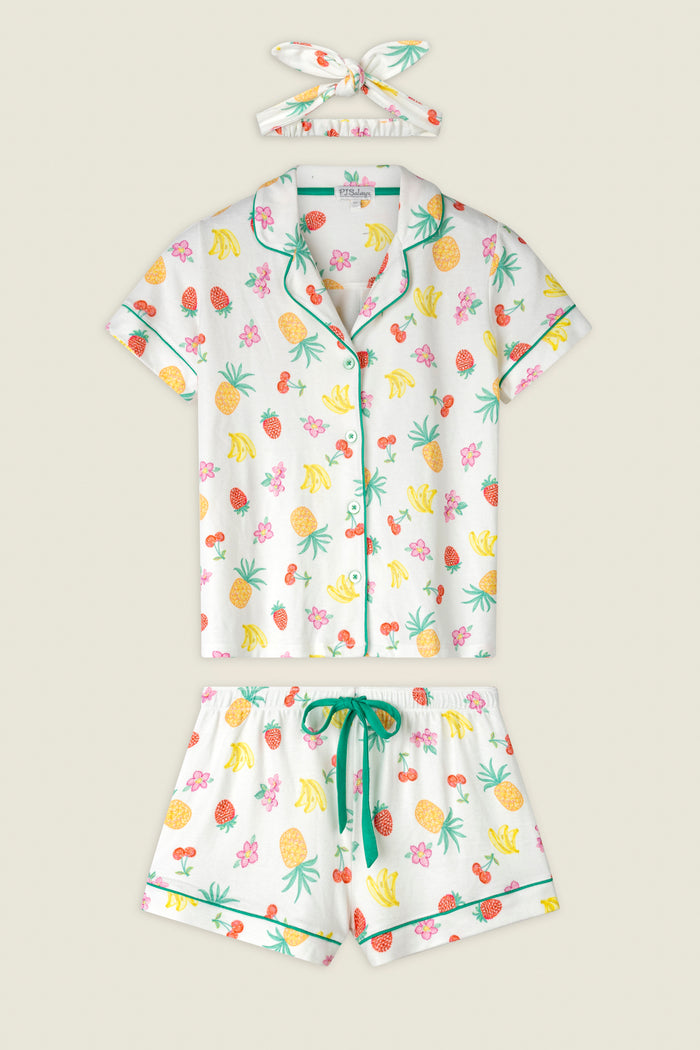 Colorful fruit pattern featuring bananas, pineapples, strawberries, and green trim on a soft fabric.