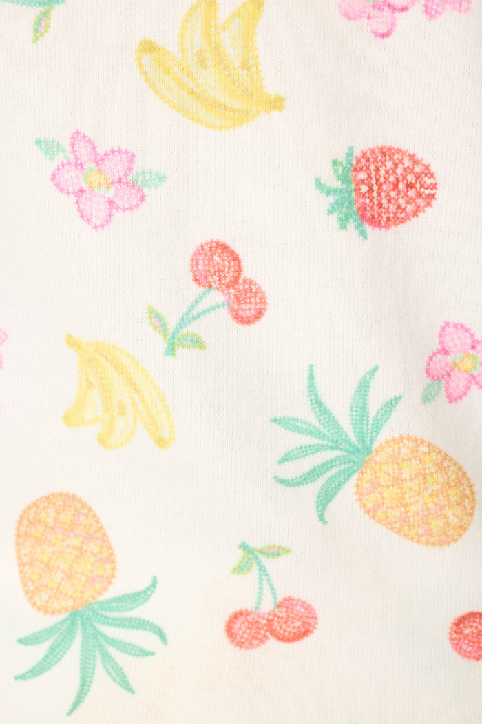 Playful pattern of illustrated bananas, pineapples, cherries, strawberries, and pink flowers on a white background.